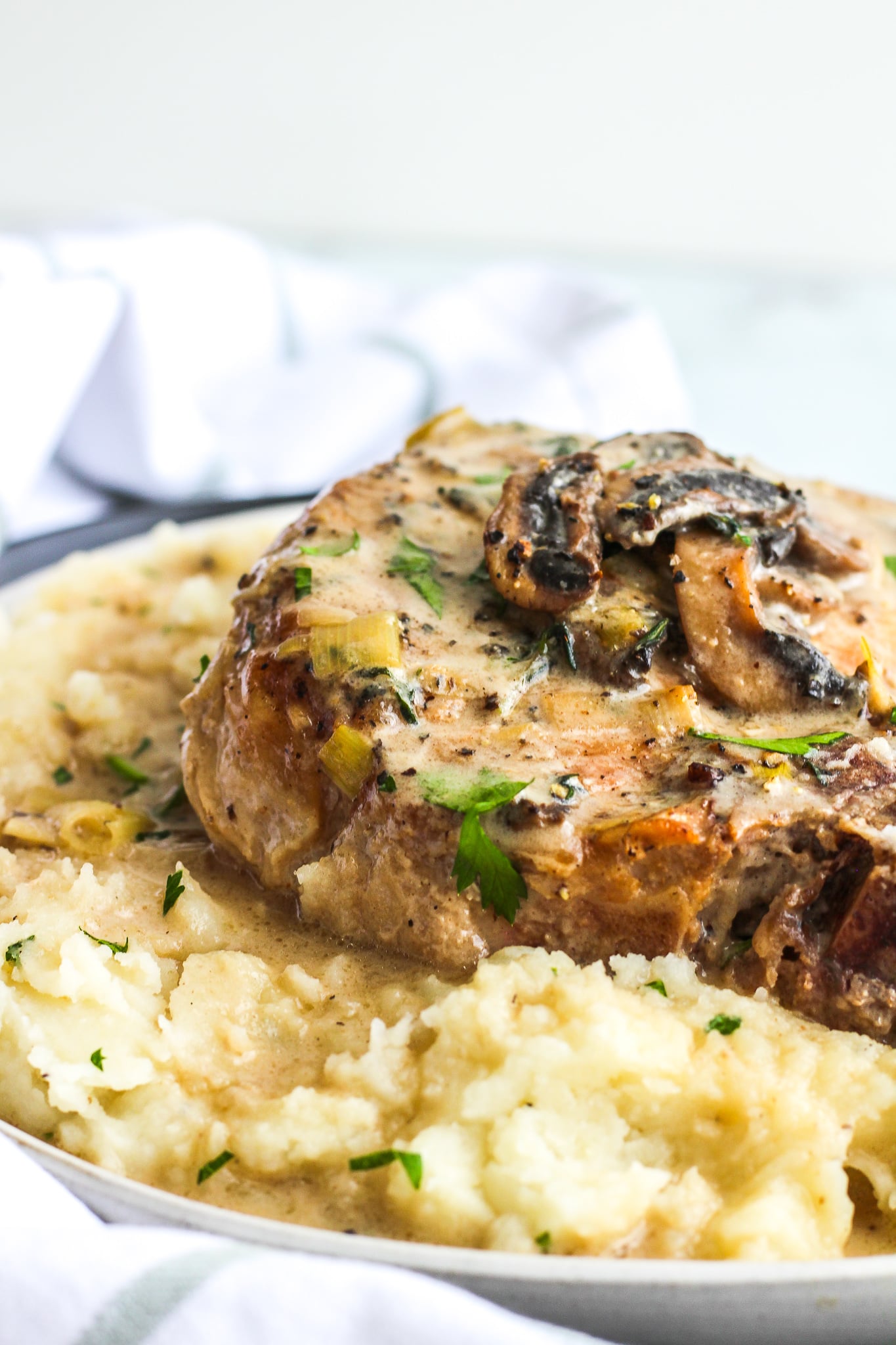 Pork Chops with Mushroom & Leek Cream Sauce served over mashed potatoes 