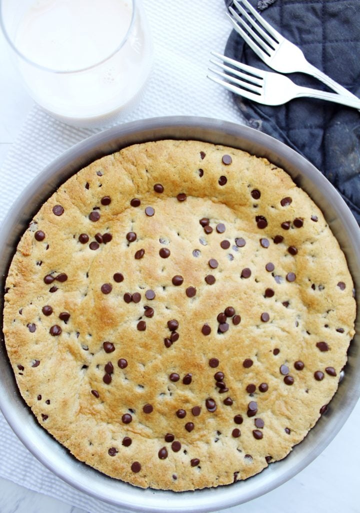 cookie skillet with glass of milk and forks