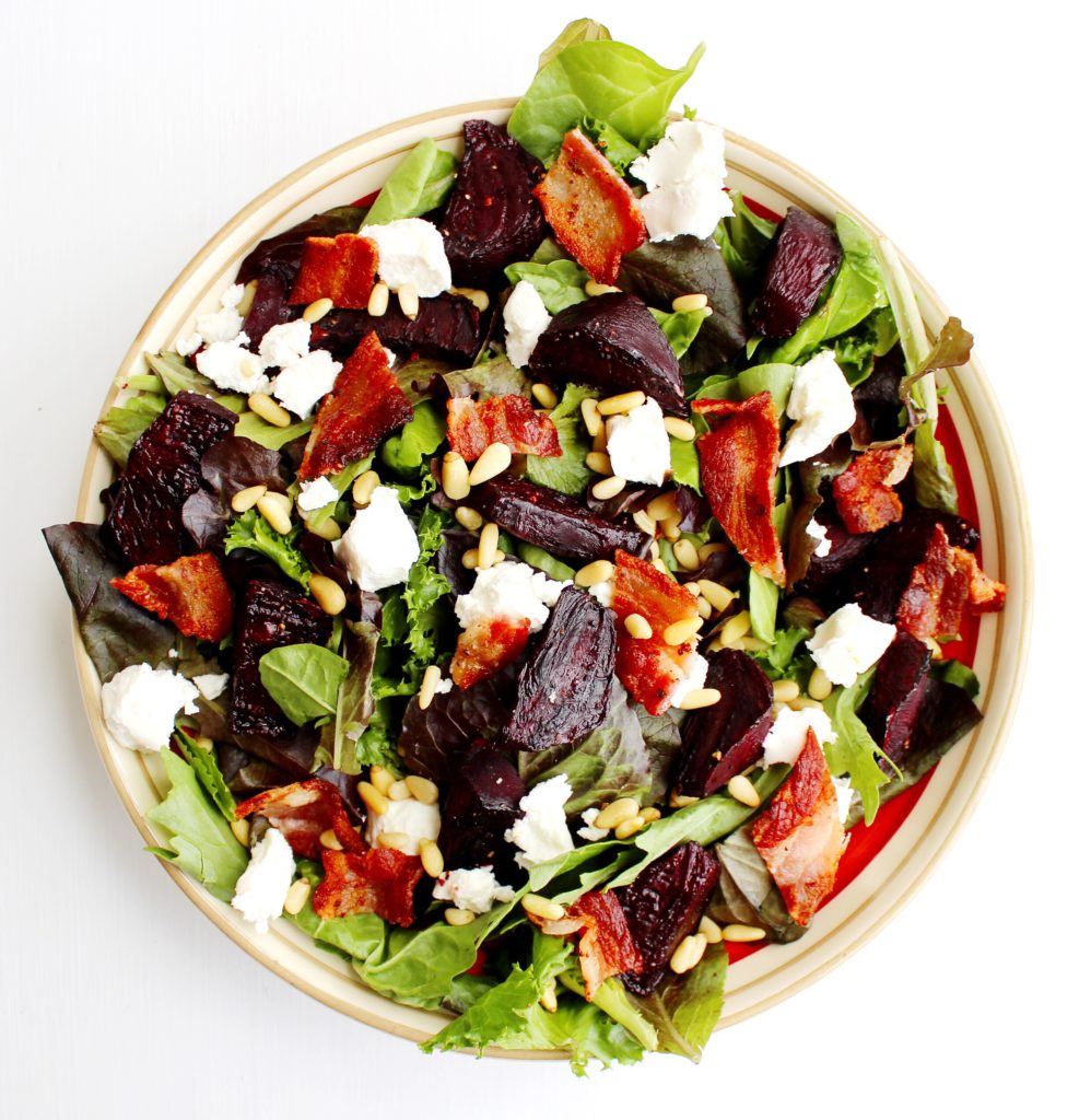 Bowl of Roasted Beet Salad with bacon, goat cheese and pine nuts