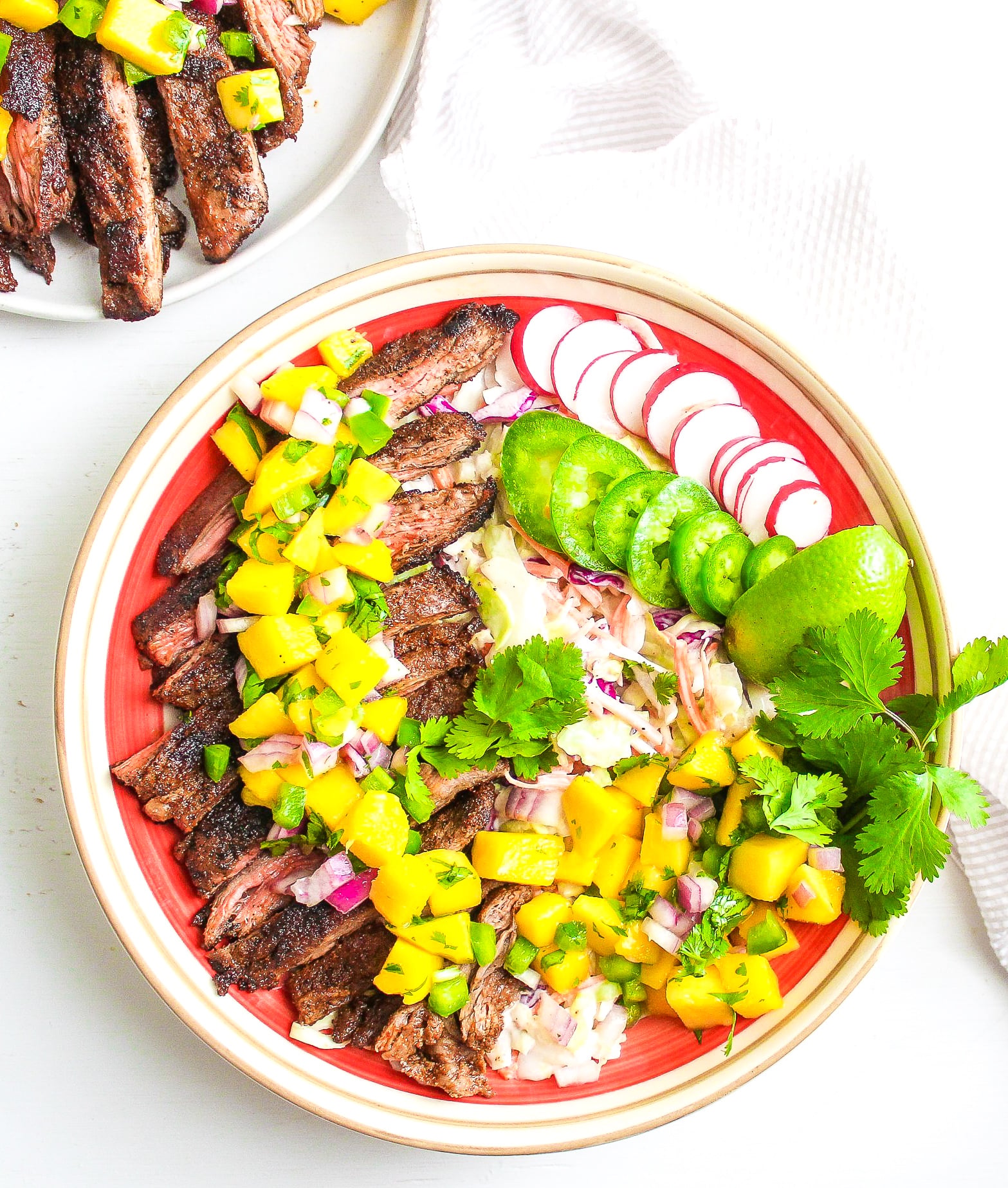 Sliced steak over coleslaw, topped with fresh mango salsa 
