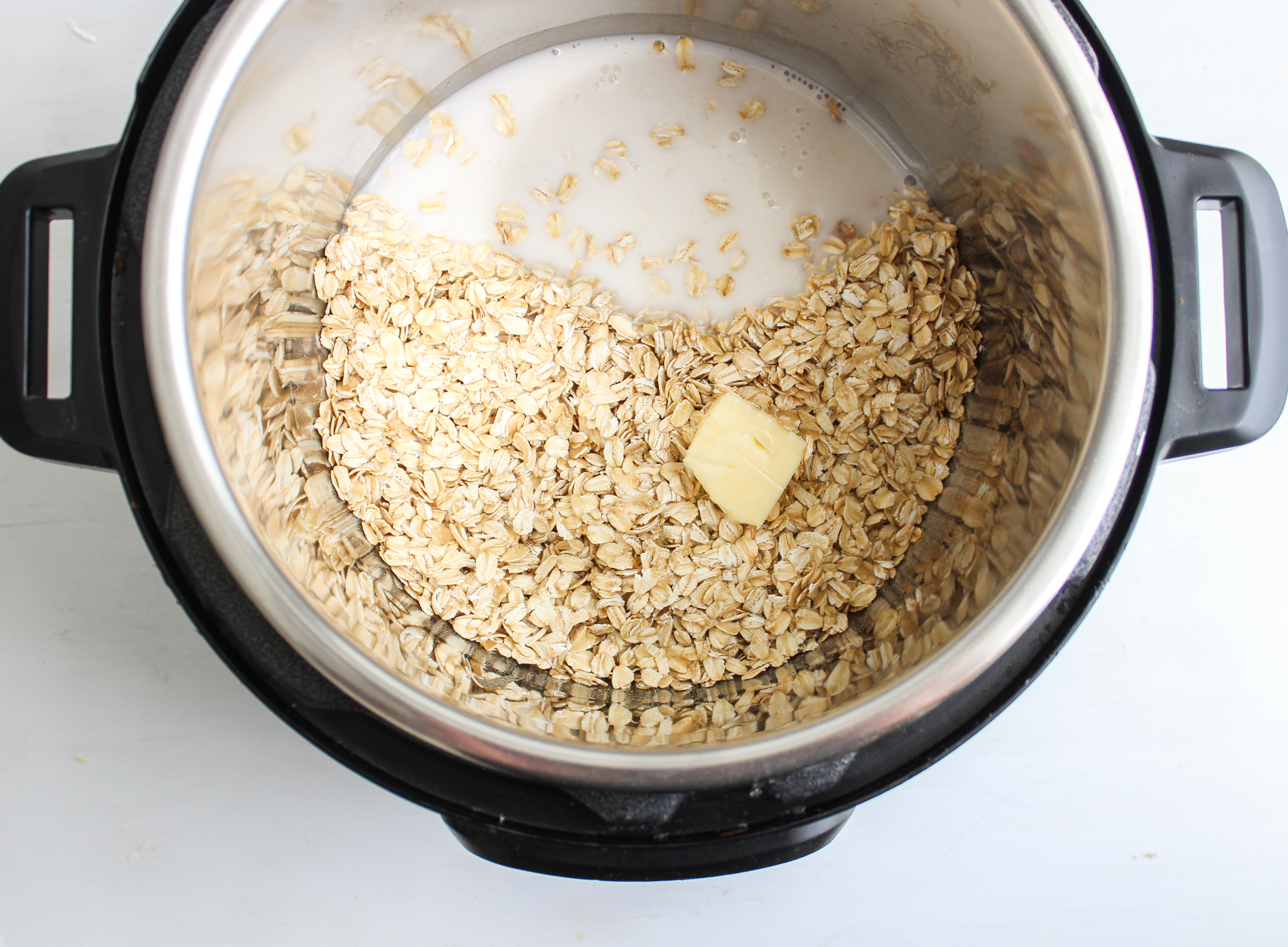 Instant pot filled with oats, almond milk and butter