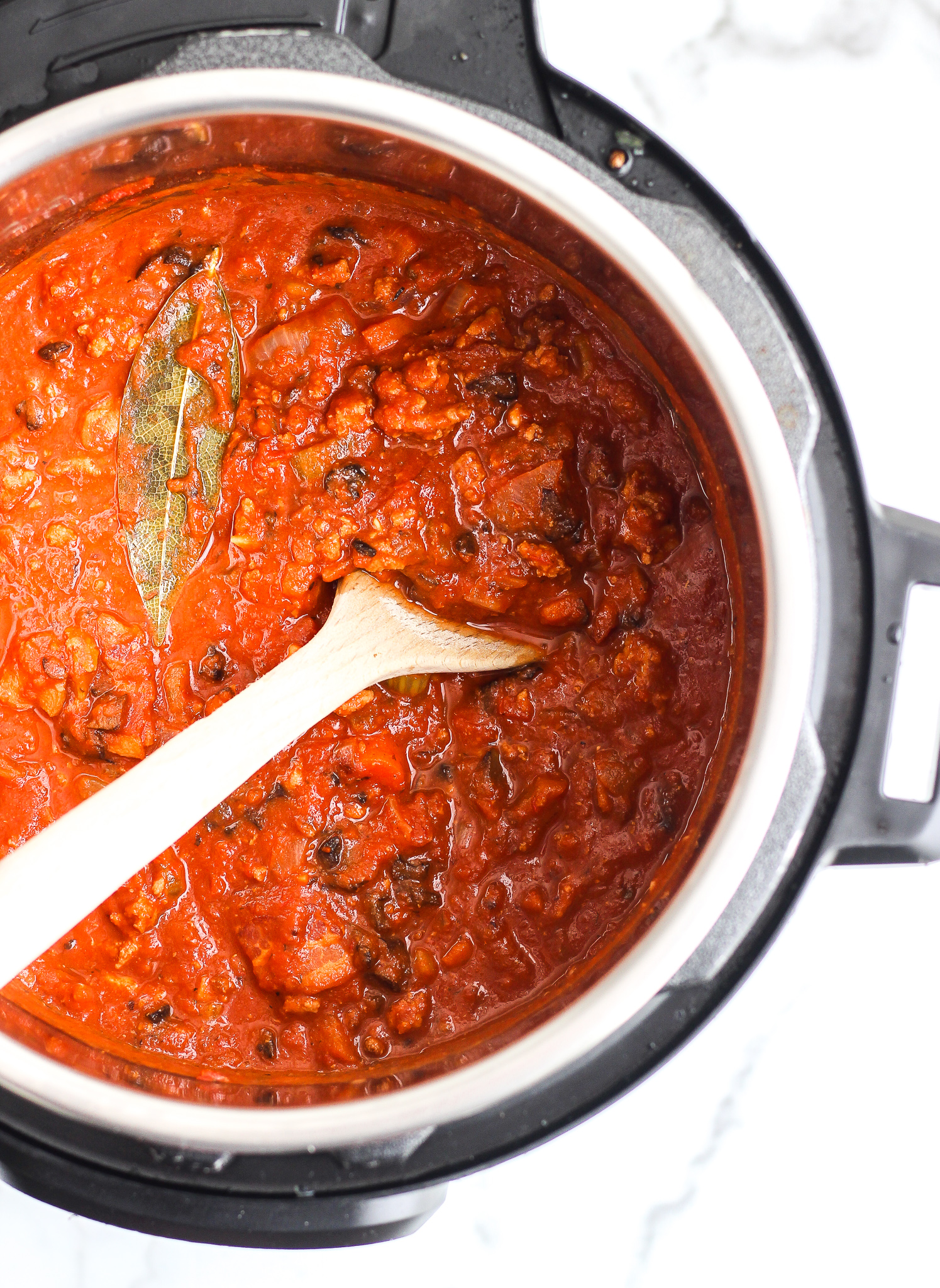 Whole30 turkey bolognese in an Instant pot with a wooden spoon 