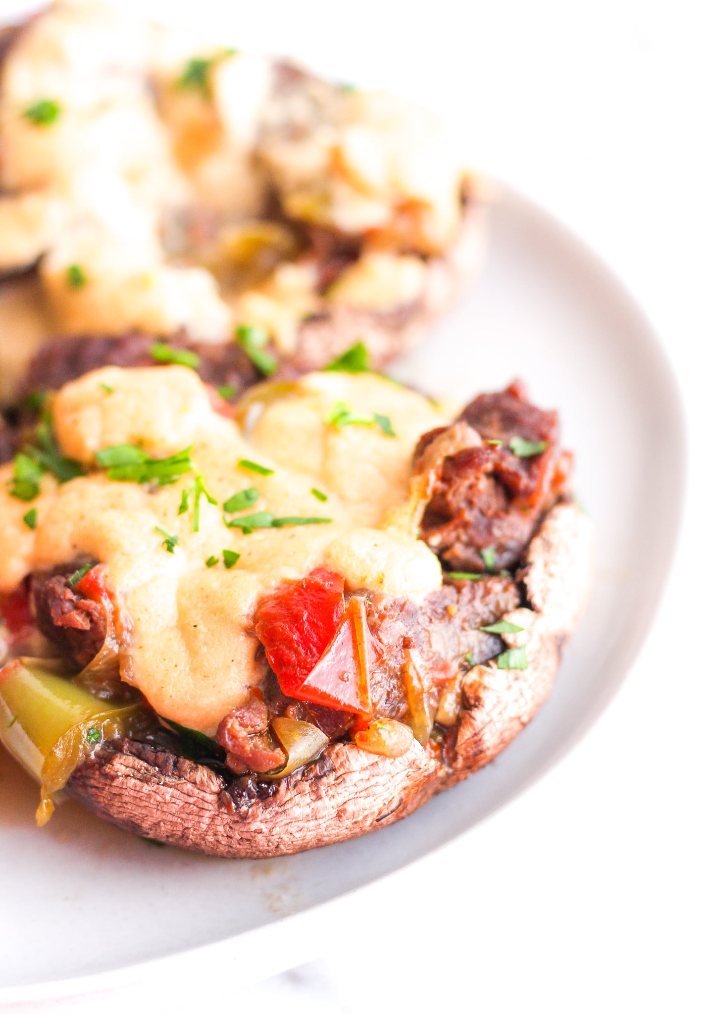 Portobello mushrooms stuffed with steak and peppers, topped with a cashew cream sauce 