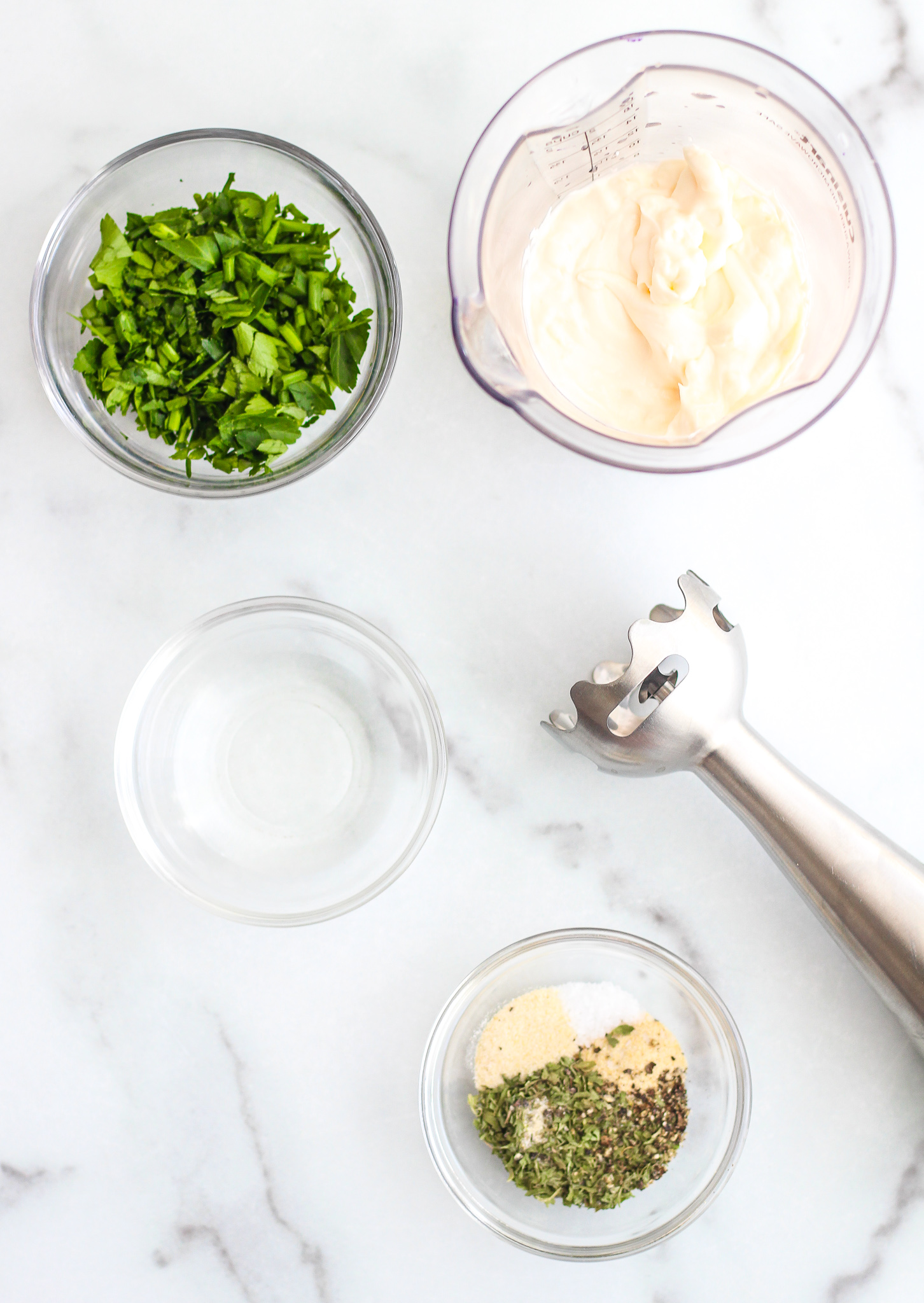ingredients for easy Whole30 ranch dressing laid out on a white granite surface 