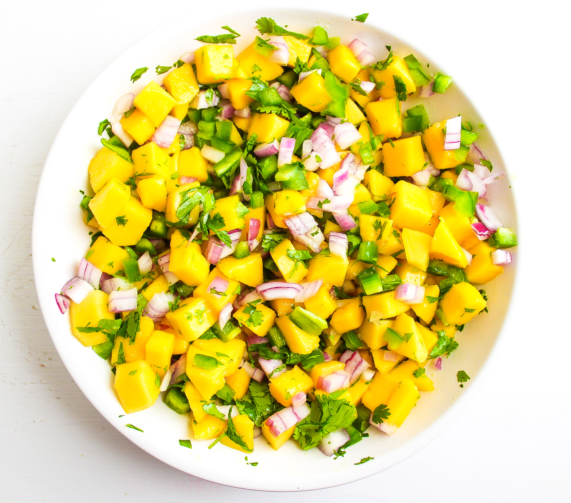 Mango salsa in a white serving dish 