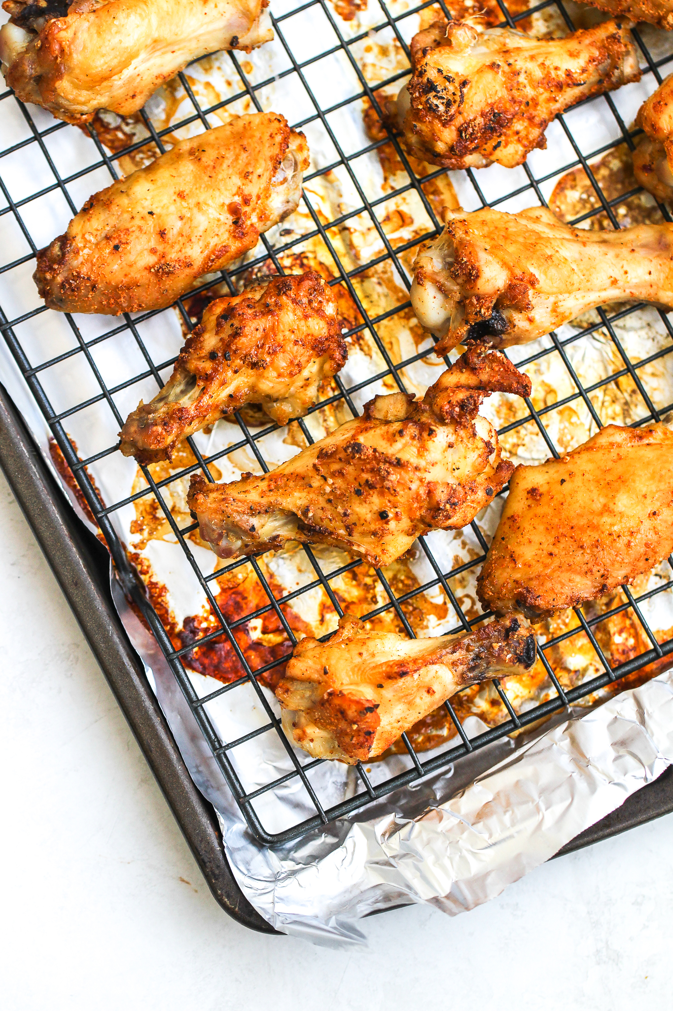 crispy baked chicken wings sections lined on a foil lined baking sheet 