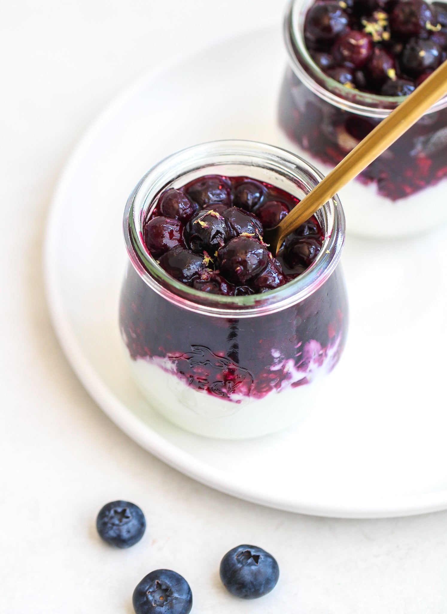 lemon blueberry yogurt parfaits layered in small glass jars 