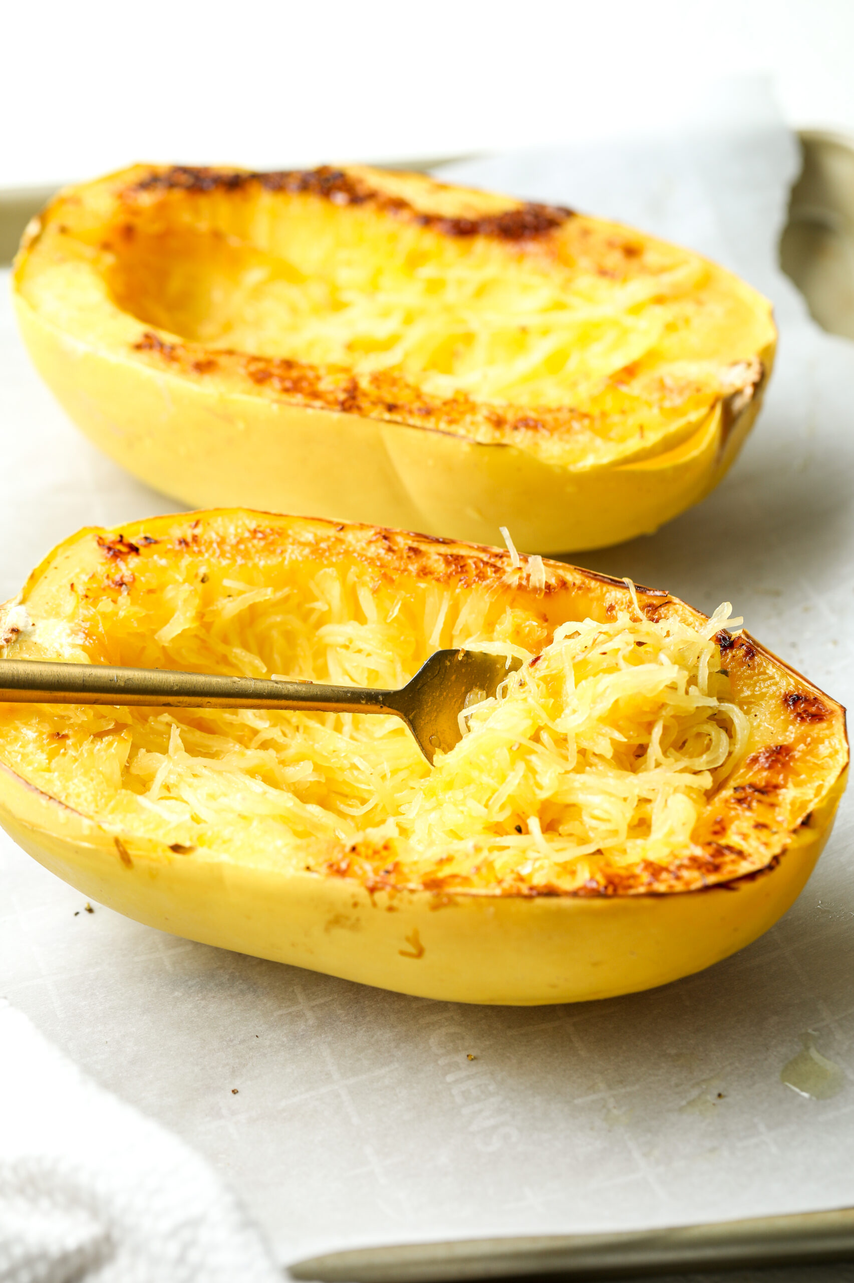 roasted spaghetti squash with a fork in it 