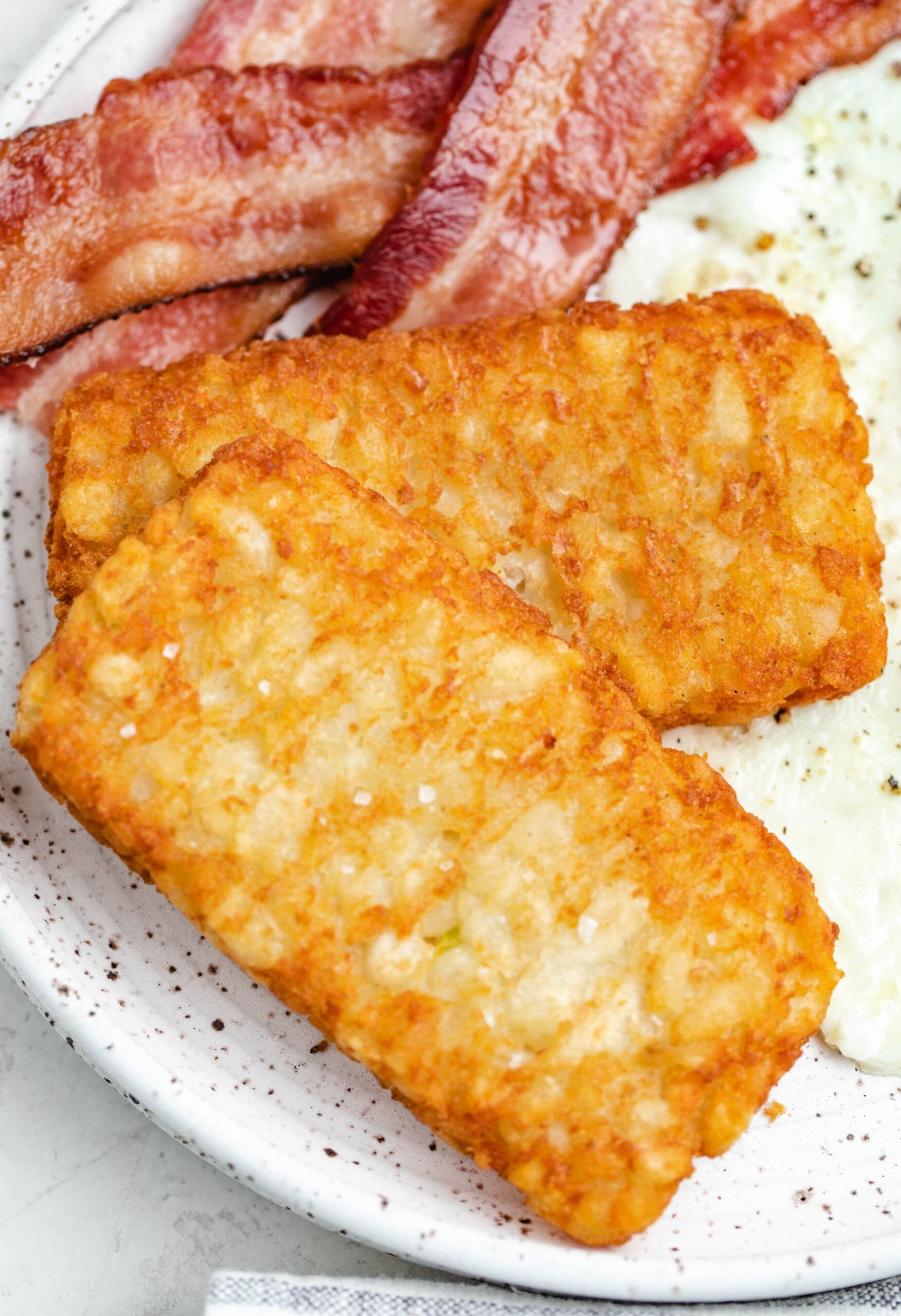 Close up shot of air fryer Hashbrown patties with salt flakes on top.