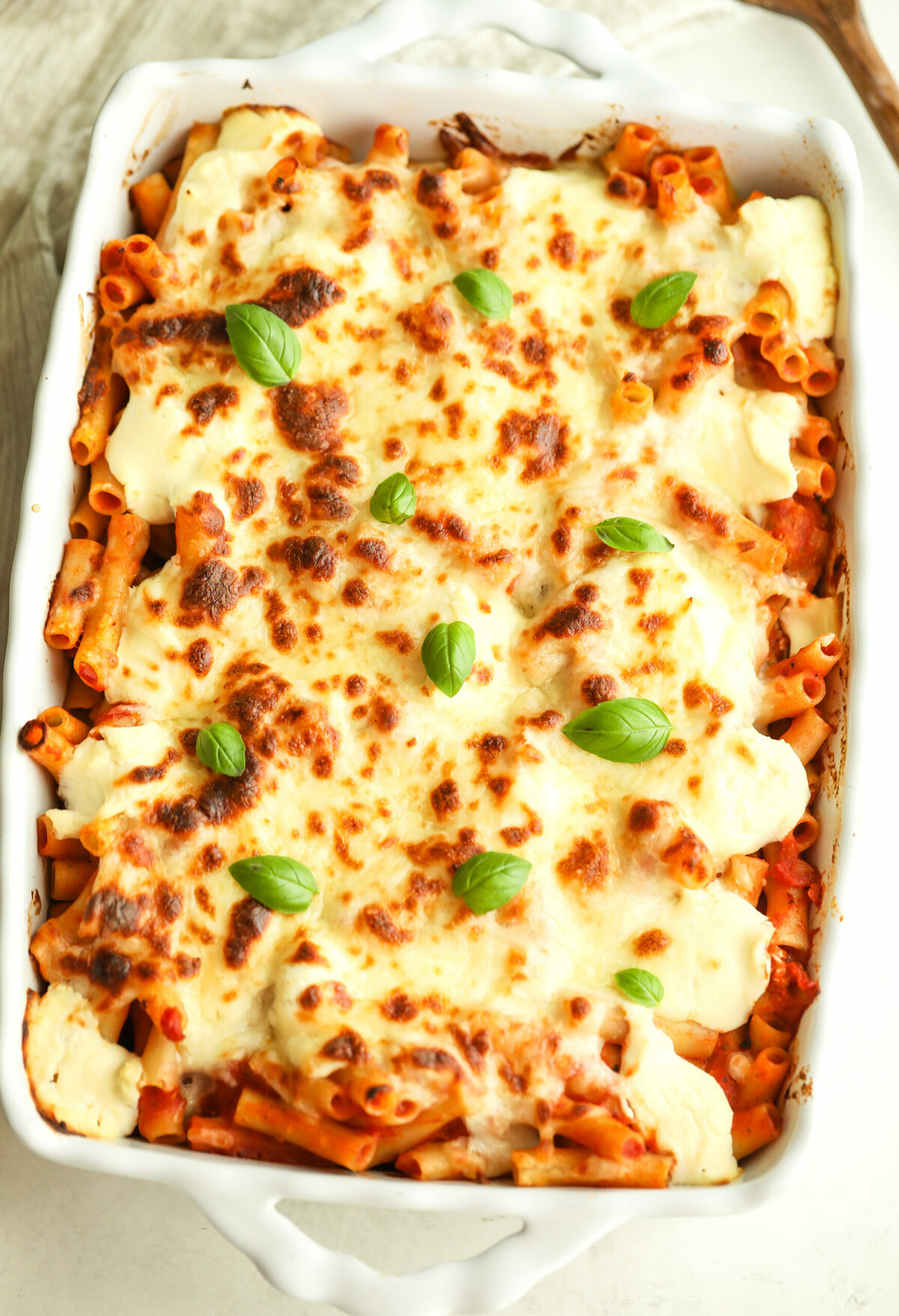 easy baked ziti in a white ceramic baking dish 