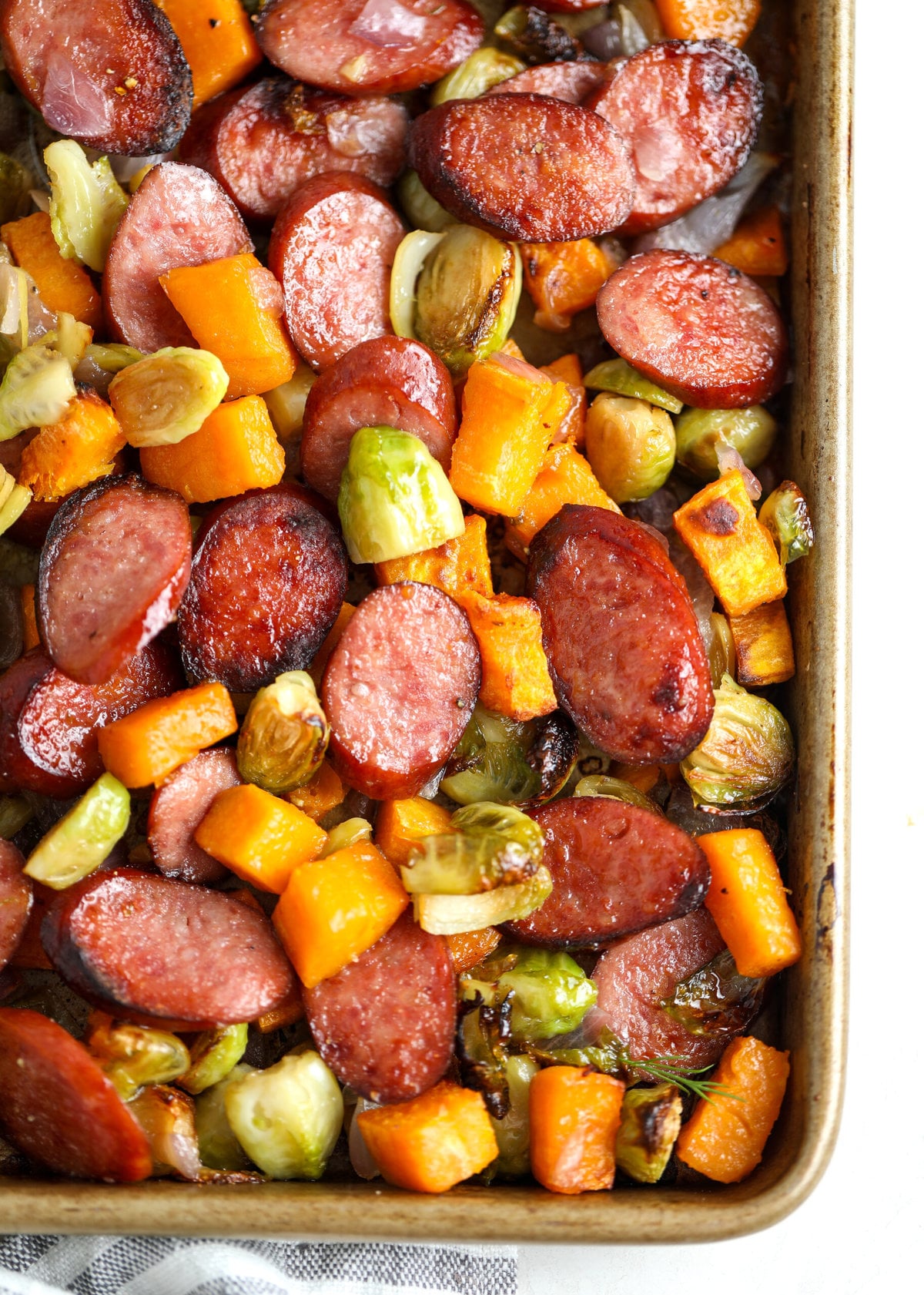 Sheet pan loaded up with perfectly roasted sausage and veggies.
