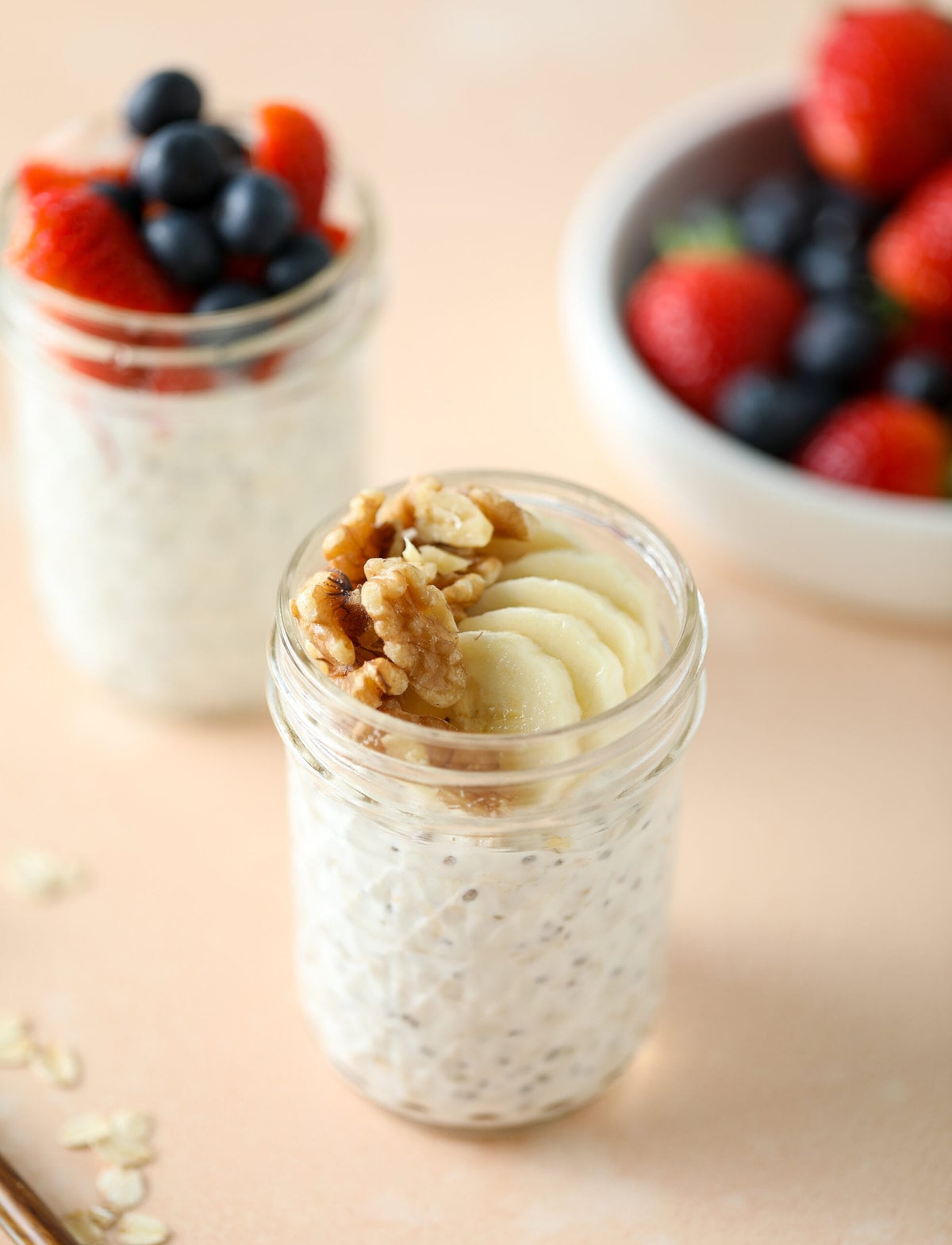 overnight oats in a glass jar topped with walnuts and freshly sliced bananas 